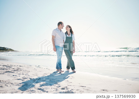 Beach, happy couple or walking in love on vacation, holiday or bonding in summer on mockup space. Smile, man or woman at ocean to travel, romance or healthy connection in relationship at sea together 137569930