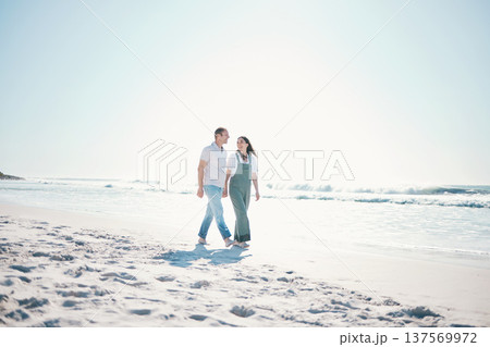 Beach, happy couple or walking while holding hands on vacation, care or bonding in summer mockup space. Man, woman or smile at ocean to travel, romance or support love in relationship together at sea 137569972