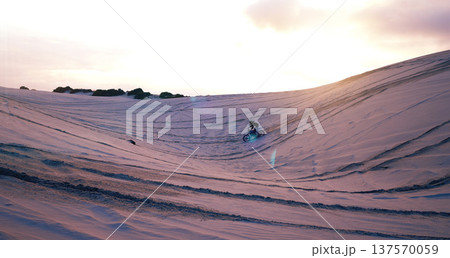 Hill, sand or athlete on motorcycle for adventure, action or fitness with wellness in outdoor workout. Sunset, desert or sports driver on motorbike on dunes in training, exercise or race challenge 137570059