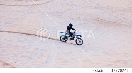 Sand, travel or athlete driving motorcycle for action, adventure or fitness with performance or adrenaline. Desert, sports or person on motorbike on dunes for training, exercise or race or challenge Sand, travel or athlete driving motorcycle for action, adventure or fitness with performance or adrenaline. Desert, sports or person on motorbike on dunes for training, exercise or race or challenge 137570241