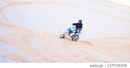 Action, desert and a person on a bike for cycling, extreme sport and adrenaline on a vacation. Sand, competition and a bike or racer for travel, training or adventure for performance on a motorbike Action, desert and a person on a bike for cycling, extreme sport and adrenaline on a vacation. Sand, competition and a bike or racer for travel, training or adventure for performance on a motorbike 137570294