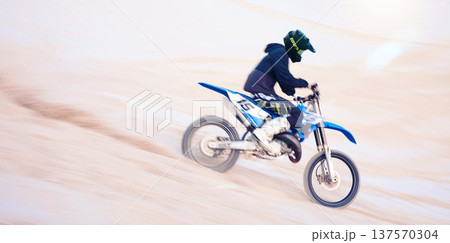 Dirt, motorbike and athlete in sports, adventure and man driving on desert, sand dune and outdoor riding in nature. Extreme sport, bike or motorcycle drive with helmet, gear or person with freedom 137570304