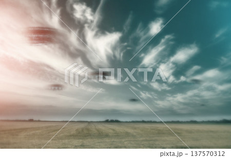 UFO, spaceship and nature with alien in sky with fantasy or science fiction event in countryside, field or landscape with clouds. Earth, aliens and extraterrestrial drone in environment with blur UFO, spaceship and nature with alien in sky with fantasy or science fiction event in countryside, field or landscape with clouds. Earth, aliens and extraterrestrial drone in environment with blur 137570312