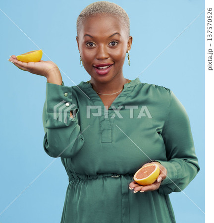 Black woman, portrait and orange for vitamin C in diet, natural nutrition or detox against a studio background. Happy African female person smile with healthy organic citrus fruit for body wellness 137570526