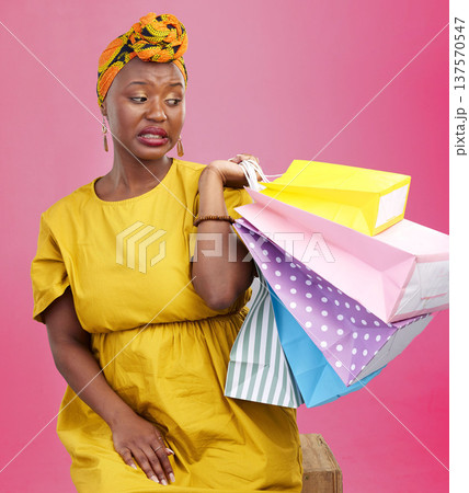 Studio bag, shopping problem or black woman with bad shop product, boutique crisis or shopaholic. Facial expression, mistake or African customer disappointed with retail present on pink background Studio bag, shopping problem or black woman with bad shop product, boutique crisis or shopaholic. Facial expression, mistake or African customer disappointed with retail present on pink background 137570547