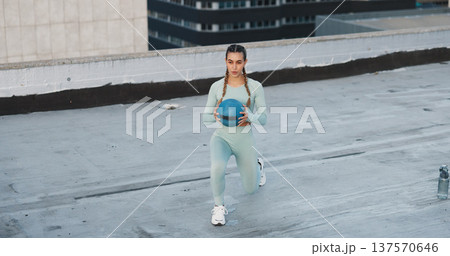 Fitness, medicine ball and woman athlete in the city for a health, wellness and cardio workout or exercise. Equipment, sports and young female person training on building rooftop in urban town. Fitness, medicine ball and woman athlete in the city for a health, wellness and cardio workout or exercise. Equipment, sports and young female person training on building rooftop in urban town. 137570646