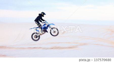 Sand, jump or athlete driving motorcycle for fitness, adventure or action with performance or adrenaline. Desert, risk or sports person on motorbike on dunes for training, exercise or race challenge Sand, jump or athlete driving motorcycle for fitness, adventure or action with performance or adrenaline. Desert, risk or sports person on motorbike on dunes for training, exercise or race challenge 137570680