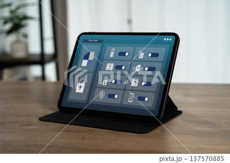 Smart home control panel on tablet with home automation interface, IoT technology dashboard for security, lighting and energy management in modern living room environment. Smart home control panel on tablet with home automation interface, IoT technology dashboard for security, lighting and energy management in modern living room environment. 137570885