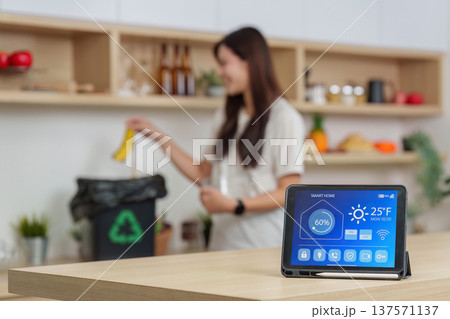 Smart Home. Woman using technology to manage waste with smart device. Smart Home. Woman using technology to manage waste with smart device. 137571137