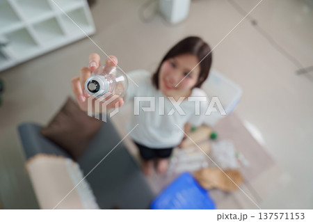 Recycling Awareness. Young woman holding plastic bottle for recycling. Recycling Awareness. Young woman holding plastic bottle for recycling. 137571153