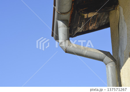 Metal Rain Gutter Pipe against Blue Sky Metal Rain Gutter Pipe against Blue Sky 137571267