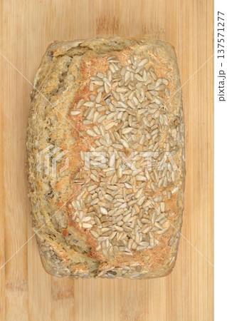 Homemade whole grain bread with sunflower seeds on wooden background 137571277