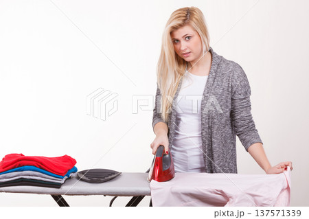 Happy woman doing ironing 137571339