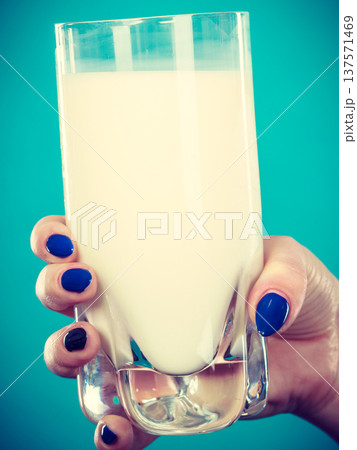 Woman hand holding glass of milk Woman hand holding glass of milk 137571469