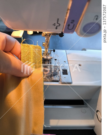 Sewing on sewing machine, close-up of presser foot during sewing lesson Sewing on sewing machine, close-up of presser foot during sewing lesson 137572087