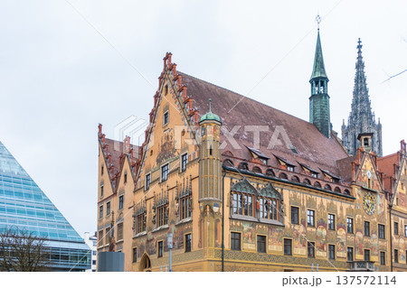 Historic Ulm Rathaus building in Germany features intricate frescoes and a tall spire. The architecture showcases traditional German design elements. Historic Ulm Rathaus building in Germany features intricate frescoes and a tall spire. The architecture showcases traditional German design elements. 137572114