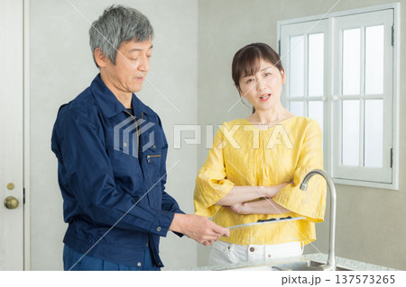 水回りの説明をする作業服の男性 水回りの説明をする作業服の男性 137573265