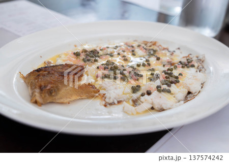Pan cooked white fish served with capers and butter sauce in a classic European restaurant style dish. Pan cooked white fish served with capers and butter sauce in a classic European restaurant style dish. 137574242