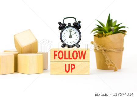 Follow up symbol. Concept word Follow up on beautiful wooden blocks. Beautiful white paper background. Beautiful black alarm clock. Business follow up concept. Copy space. Follow up symbol. Concept word Follow up on beautiful wooden blocks. Beautiful white paper background. Beautiful black alarm clock. Business follow up concept. Copy space. 137574314