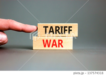 Trade tariff war symbol. Concept word Tariff war on beautiful wooden blocks. Beautiful grey paper background. Businessman's hand. Business trade tariff wars concept. Copy space. Trade tariff war symbol. Concept word Tariff war on beautiful wooden blocks. Beautiful grey paper background. Businessman's hand. Business trade tariff wars concept. Copy space. 137574318