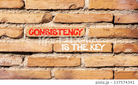 Consistency is the key symbol. Concept words Consistency is the key on beautiful brick wall. Beautiful brick wall background. Business consistency is the key concept. Copy space. Consistency is the key symbol. Concept words Consistency is the key on beautiful brick wall. Beautiful brick wall background. Business consistency is the key concept. Copy space. 137574341