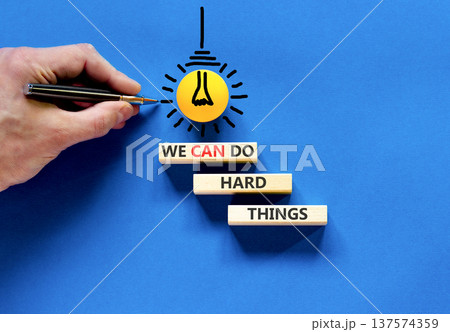 Support, help we can do hard things symbol. Concept words We can do hard things on beautiful wooden blocks. Beautiful blue background. Business we can do hard things concept. Copy space. Support, help we can do hard things symbol. Concept words We can do hard things on beautiful wooden blocks. Beautiful blue background. Business we can do hard things concept. Copy space. 137574359