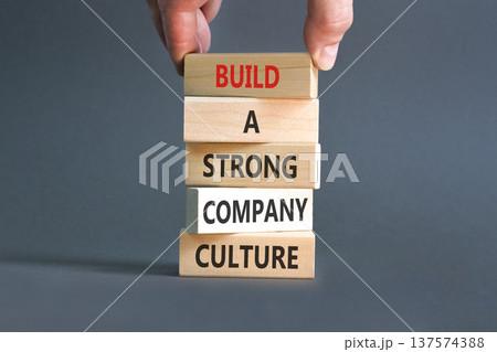 Strong company culture symbol. Concept words Build a strong company culture on beautiful wooden blocks. Beautiful grey paper background. Business strong company culture concept. Copy space. Strong company culture symbol. Concept words Build a strong company culture on beautiful wooden blocks. Beautiful grey paper background. Business strong company culture concept. Copy space. 137574388