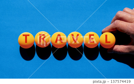 Travel traveling touristic word symbol. Concept word Travel on beautiful orange table tennis ping pong balls. Beautiful blue background. Business travel traveling touristic word concept. Copy space. Travel traveling touristic word symbol. Concept word Travel on beautiful orange table tennis ping pong balls. Beautiful blue background. Business travel traveling touristic word concept. Copy space. 137574419