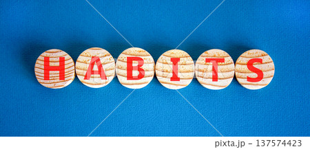 Habits support and help symbol. Concept word Habits on beautiful wooden circles. Beautiful blue background. Business psychological habits support and help concept. Copy space. Habits support and help symbol. Concept word Habits on beautiful wooden circles. Beautiful blue background. Business psychological habits support and help concept. Copy space. 137574423