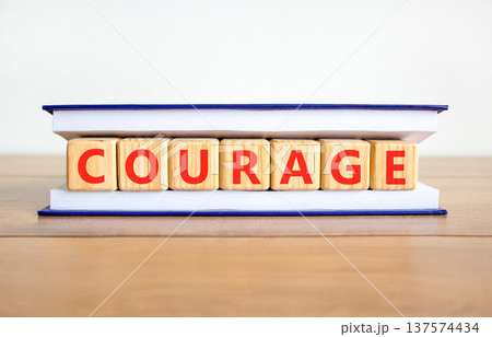Courage symbol. Concept word Courage on beautiful wooden blocks in book. Beautiful wooden table white background. Business courage concept. Copy space. Courage symbol. Concept word Courage on beautiful wooden blocks in book. Beautiful wooden table white background. Business courage concept. Copy space. 137574434