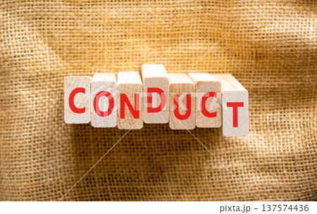 Conduct symbol. Concept word Conduct on beautiful wooden blocks. Beautiful canvas background. Business conduct concept. Copy space. Conduct symbol. Concept word Conduct on beautiful wooden blocks. Beautiful canvas background. Business conduct concept. Copy space. 137574436