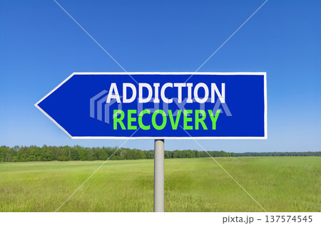 Addiction recovery symbol. Concept words Addiction recovery on beautiful blue road sign. Beautiful blue sky green grass field background. Psychology addiction recovery concept. Copy space. Addiction recovery symbol. Concept words Addiction recovery on beautiful blue road sign. Beautiful blue sky green grass field background. Psychology addiction recovery concept. Copy space. 137574545