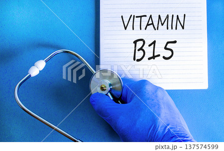 Vitamin B15 pantothenic acid symbol. Concept words Vitamin B15 on beautiful white note. Doctor's hand in blue medical glove. Beautiful blue background. Medical healthy lifestyle Vitamin B15 concept. Vitamin B15 pantothenic acid symbol. Concept words Vitamin B15 on beautiful white note. Doctor's hand in blue medical glove. Beautiful blue background. Medical healthy lifestyle Vitamin B15 concept. 137574599