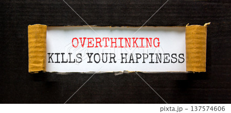 Overthinking kills your happiness symbol. Concept words Overthinking kills your happiness on white paper. Beautiful black paper background. Business overthinking kills happiness concept. Copy space. Overthinking kills your happiness symbol. Concept words Overthinking kills your happiness on white paper. Beautiful black paper background. Business overthinking kills happiness concept. Copy space. 137574606