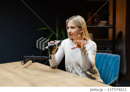 Excited female podcaster celebrating success in her home studio 137574811