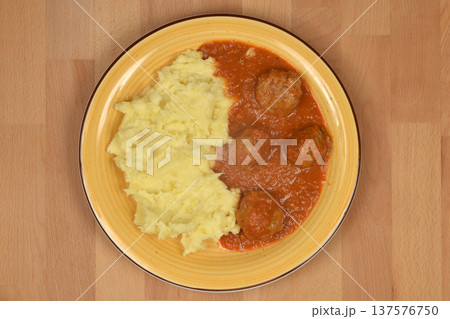 Meatballs in tomato sauce with mashed potatoes 137576750
