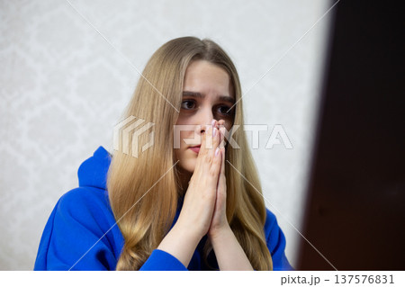 Young woman asks AI chatbot for guidance, hands clasped in digital prayer. She interacts with artificial intelligence on laptop, seeking answers. Futuristic tech concept Young woman asks AI chatbot for guidance, hands clasped in digital prayer. She interacts with artificial intelligence on laptop, seeking answers. Futuristic tech concept 137576831