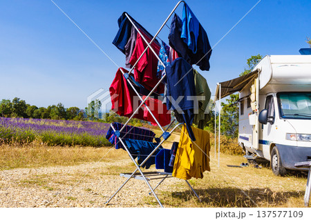 Clothes hanging to dry outdoors by camping car. Caravan vacation. Clothes hanging to dry outdoors by camping car. Caravan vacation. 137577109
