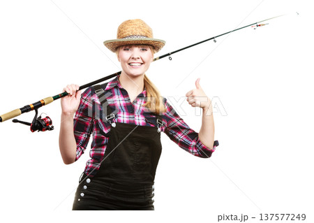 Happy woman in sun hat holding fishing rod Happy woman in sun hat holding fishing rod 137577249