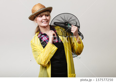 Happy woman holding empty fishing keepnet 137577250