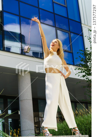 Cheerful fashionable woman in city 137577297