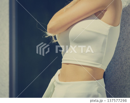 Unrecognizable woman wearing white crop top 137577298