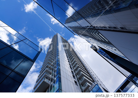 Modern skyscrapers and glass office buildings viewed from below against blue sky in Tel Aviv Israel Modern skyscrapers and glass office buildings viewed from below against blue sky in Tel Aviv Israel 137577333