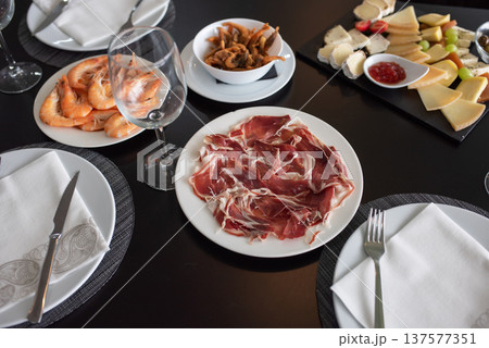Food on the table. Jamon on a plate for lunch. 137577351