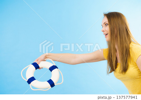 Girl holds life buoy rescue ring 137577941