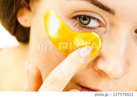 Woman with gold patches under eyes 137578022