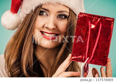 Happy Christmas woman holds red gift bag 137578069