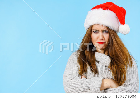 Tired woman wearing santa hat Tired woman wearing santa hat 137578084