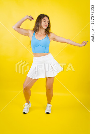 Young woman dancing, feeling active and energetic Young woman dancing, feeling active and energetic 137578352
