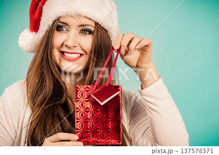 Happy Christmas woman holds red gift bag 137578371